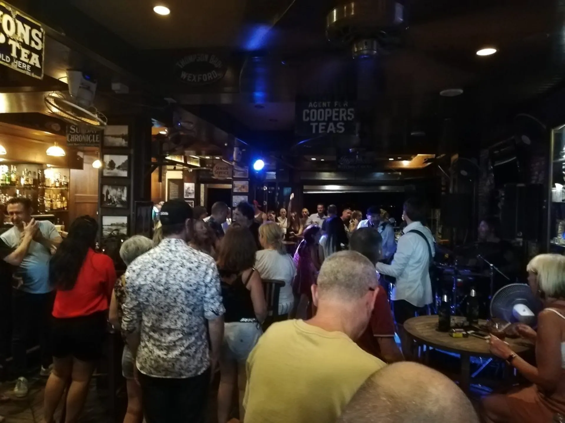 A packed night inside the Emerald, with a live band playing at the back of the bar
